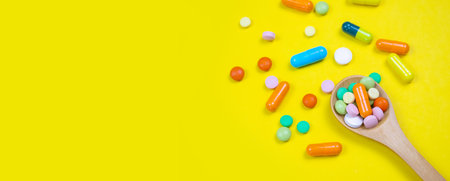 medicines, pills, mask, virus on a yellow background covidの写真素材