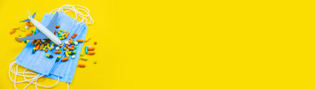 Hand in glove holding model airplanes on yellow background. Airplane model on hand and face medical...