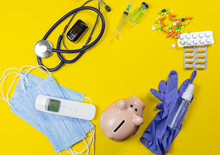 medical supplies on a yellow background, pills water treatment mask virus. Selective focusの写真素材