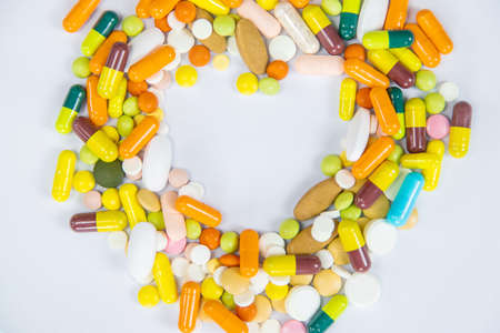 medical supplies on a yellow background, pills water treatment mask virus. Selective focusの写真素材