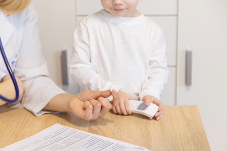 child being checked by a doctor. Selective focusの写真素材
