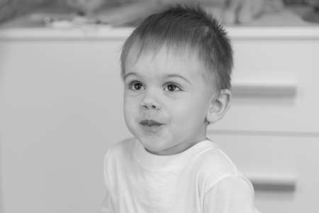 The child drinks water from a glass.の写真素材