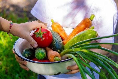 Children in the garden with vegetables in their hands. Selective focus. nature.