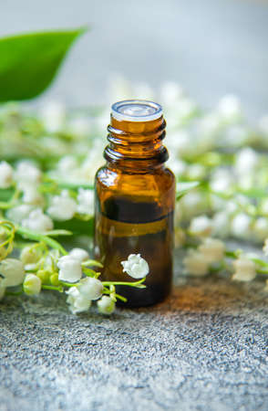 Lily of the valley essential oil in a small bottle. Selective focus. Nature.の写真素材