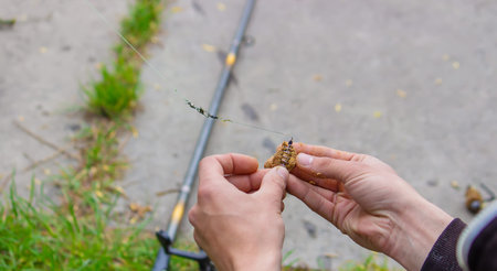 fishing on the river a man puts a bait for catching fish, selective focus. Nature