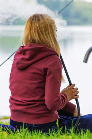 The girl smokes a hookah on the river bank. Nature. Selective focusの写真素材