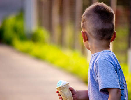 child eats ice cream in nature, ice cream in a cup. Nature. Selective focusの写真素材