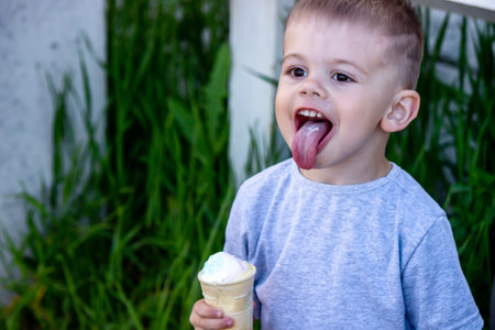 child eats ice cream in nature, ice cream in a cup. Nature. Selective focusの写真素材