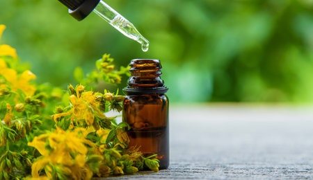 An essential oil extract of St. John's wort herb. Selective focus. Nature.