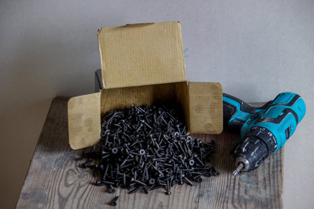 self-tapping screws on a wooden background, a selection of different self-tapping screws for different wall materials and surfaces. Selective focusの写真素材