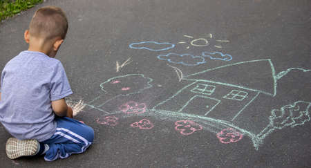 children drawing on asphalt family house. Selective focusの写真素材