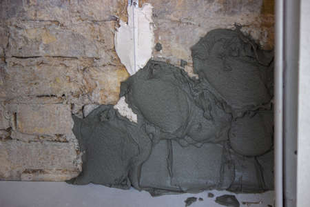 man plastering the wall. Construction, repairs in the house. Selective focusの写真素材