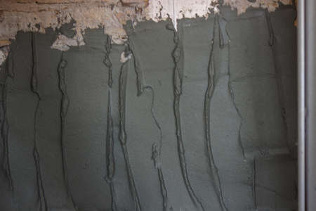 man plastering the wall. Construction, repairs in the house. Selective focusの写真素材