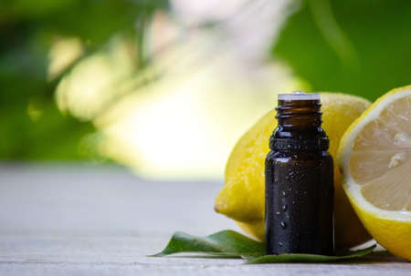 A bottle of lemon essential oil is an alternative medicine. Selective focusの写真素材