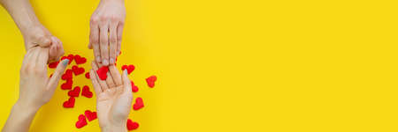 Silhouette hand in heart shape with sunrise in the middle and beach backgroundの写真素材