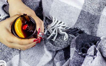 Hot mulled wine in male and female hands, spices. Sweet home conceptの写真素材