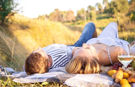 couple in love drinking wine on a picnic. Nature. Selective focus