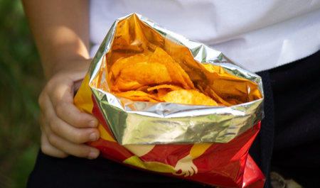 child eats potato chips. Selective focus
