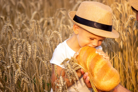 a child in a wheat field eats bread. Nature. selective focus