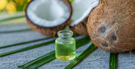 Coconut fruits and coconut oil isolated on table background. selective focusの写真素材