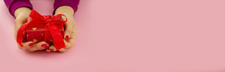 valentine. heart in hands on a pink background. selective focus