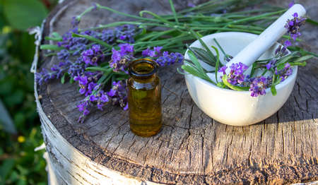Herbal oil and lavender flowers on a wooden background. Nature. selective focusの写真素材