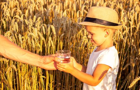 Father and child with a glass of water. Selective focus. Kid.