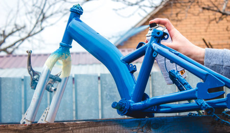Man paints a bicycle. selective focus