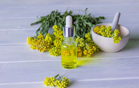Bottle with essential oil of tansy extract, tincture. The concept of aromatherapy, spa and herbal medicine. selective focusの写真素材