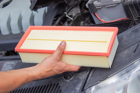 Technician changes car filter, car spare part. car service concept. selective focus