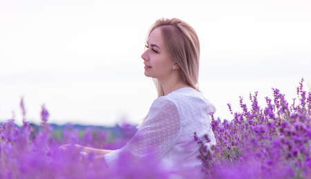 the girl is resting in the lavender field. selective focusの写真素材