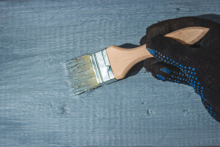 A hand with a brush that paints a tree gray. selective focusの写真素材