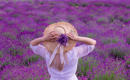 the girl is resting in the lavender field. selective focusの写真素材