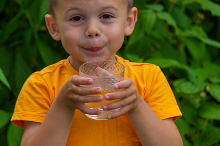 The child drinks clean water in summer. selective focus.の写真素材
