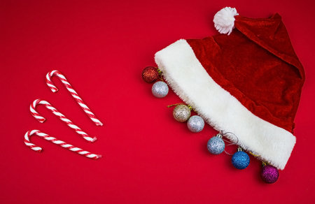 christmas composition. Christmas red decorations, fir tree branches on red background. flat lay.の写真素材