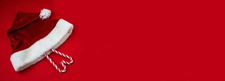 christmas composition. Christmas red decorations, fir tree branches on red background. flat lay.の写真素材