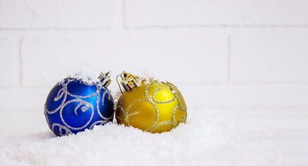 Christmas toys on a light background, in artificial snow. selective focusの写真素材