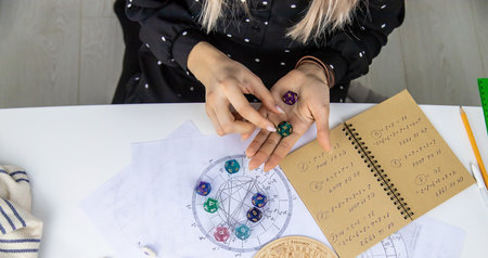 Woman numerologist astrologer counts numbers. selective focus. people.の写真素材