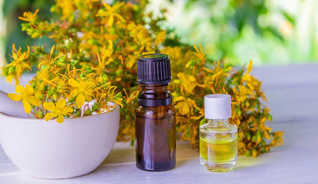 St. John's wort essential oil in a small bottle. selective focus. Nature.の写真素材