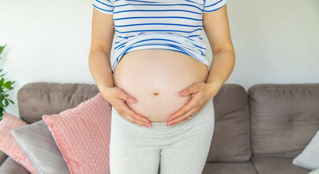 Pregnant woman hugs her belly. selective focus. Cute.の写真素材