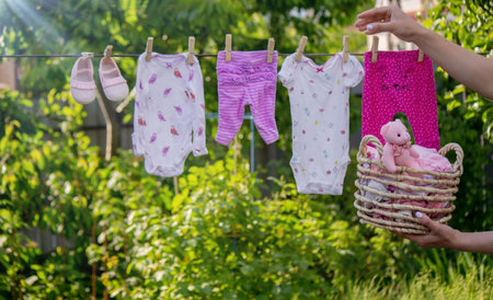 washing baby clothes. Linen dries in the fresh air. selective focus. nature.の写真素材