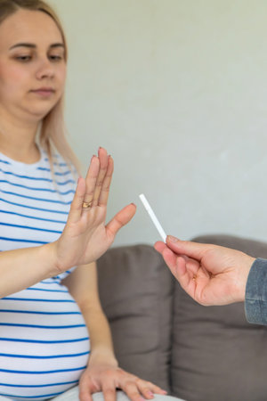 The pregnant woman refuses to smoke. selective focus. home.