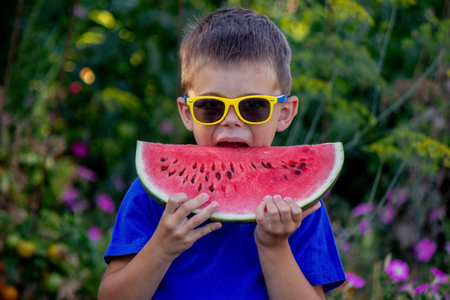A child eats a watermelon. selective focus. Natureの写真素材