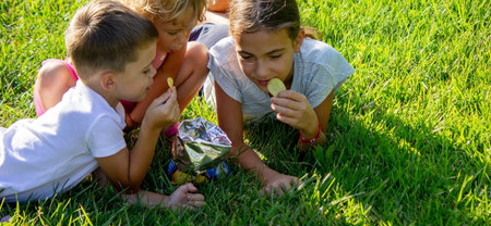 happy children eat chips. selective focus. natureの写真素材