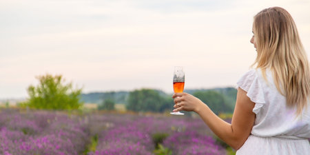 girl drinks champagne in a lavender field. Selective focus. nature