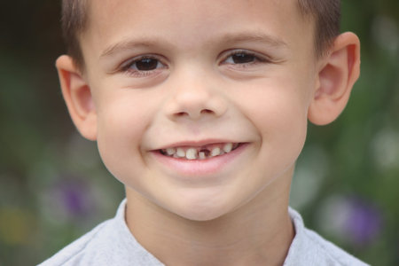 a boy without a tooth. Selective focus. nature