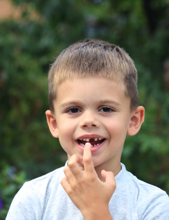 a boy without a tooth. Selective focus. nature