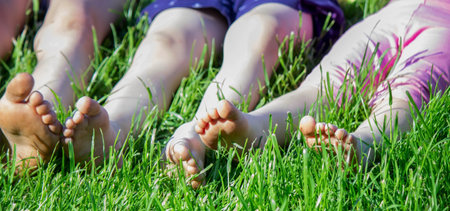 Children's legs on green grass. Selective focus. childの写真素材
