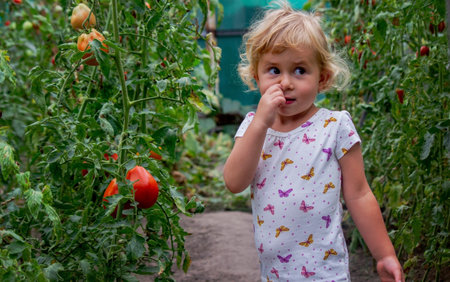 A beautiful girl looks at the camera and picks her nose. selective focusの写真素材