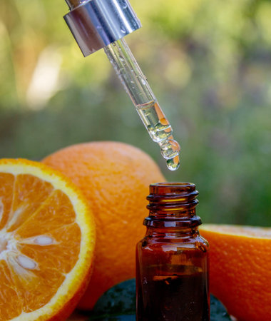Essential extract of orange oil in a small bottle.の写真素材